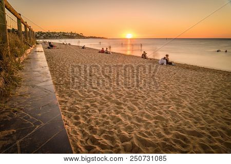 People Watching The Sunset At The Beach In Frankston, Australia