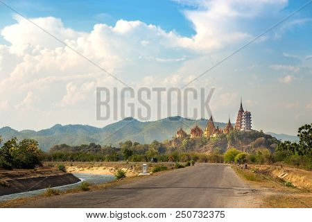 Big Buddha Temple, Wat Tham Suea, On Mountain With View From Country Road And River Side In Kanchana