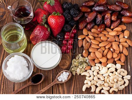 Berries, Nuts, Coconut Milk And Butter, Maple Sirup. Ingredients For Raw Vegan Cheesecake With Caram