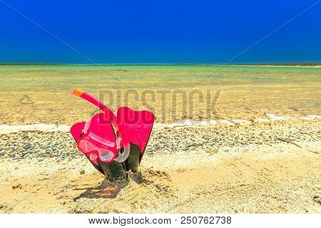 Close-up Of Scuba Mask With Fins In Pink Color On The Sand Of Tropical Natural Pool Of Little Lagoon