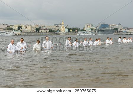Kiev, Ukraine. July 22 2018 Pastors Baptize People In The River. Mass Water Baptism On The Beach