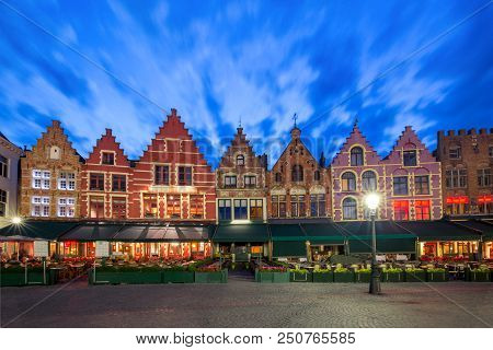 Typical Flemish Colored Houses On The Grote Markt Or Market Square In The Center Of Bruges During Ev