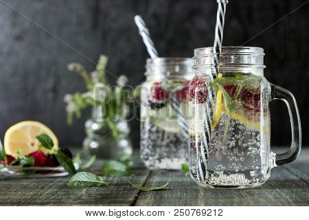A Cooling Lemon Drink In A Glass Cup On A Wooden Table