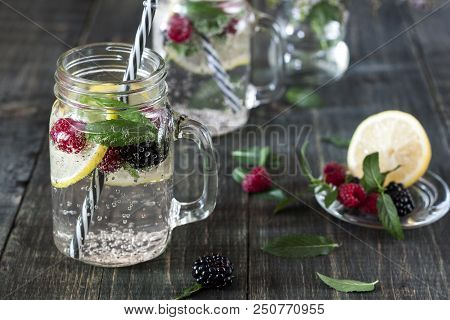 A Cooling Lemon Drink In A Glass Cup On A Wooden Table
