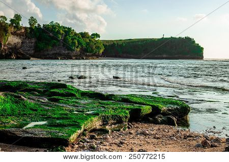 Mossy In Ocean Near Rocks Balangan Beach Bali