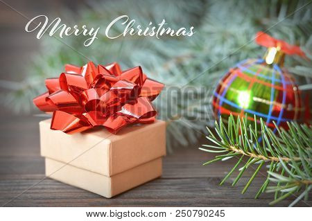 Merry Chrictmas Card With Christmas Gift On Wooden Background
