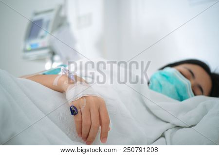 Close Up Young Woman Patient Lay On Bed In Hospital With Intravenous Normal Saline