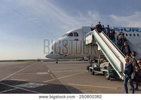 Passengers Go Out Of The Arrived Plane.