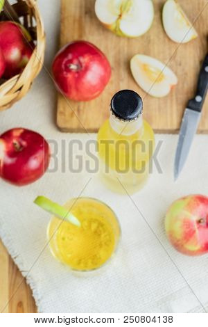 Top View Cidre Bottle On And Ripe Apples Rustic Wooden Table. Glass And Bottle Of Home Made Cider An