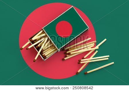 Bangladesh Flag  Is Shown On An Open Matchbox, From Which Several Matches Fall And Lies On A Large F