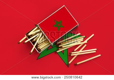 Morocco Flag  Is Shown On An Open Matchbox, From Which Several Matches Fall And Lies On A Large Flag