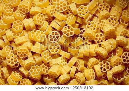 Raw Uncooked Rotelle Dry Italian Pasta. Ruote, Wagon Wheel Shaped