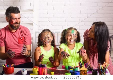 Girls Drawing With Mother And Father. Family Smiling With Hands Colored In Paints. Arts And Crafts. 