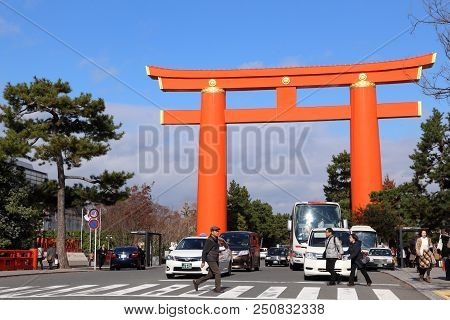 Kyoto, Japan - November 24, 2016: People Walk By The Largest Torii Gate In Japan. Kyoto Has 17 Unesc