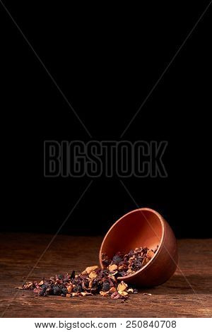 Raspberry Tea In Brown Clay Bowl. Wooden Background.