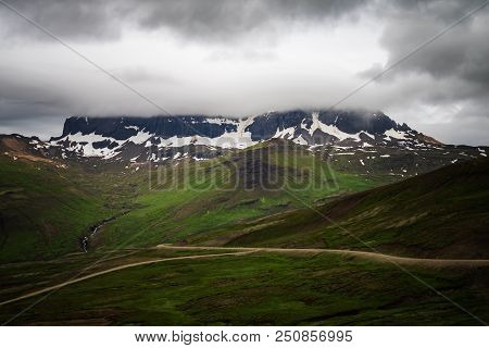 Scenic View Of Green Mountain With Dramatic Sky Near Borgarfjorour Eystri In East Iceland.