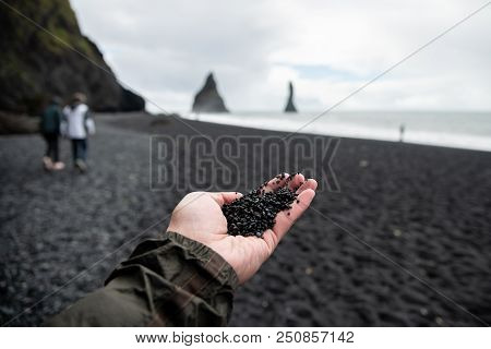 Black Rocks On Hand From Black Sand Beach Reynisfjara Vik ,iceland.