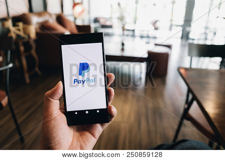 Chiangmai, Thailand - July 07, 2018: Hand Holding Sony Mobile Phone On Paypal Logo Screen. Paypal Is