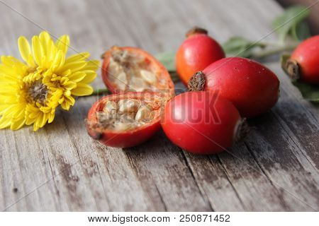 Health Flower Rosehip Berries On Wooden Background. Autumn Composition. Useful Tea Ingrid.