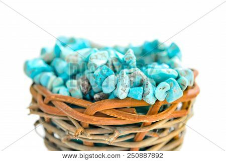 Pile Stones Of Raw Turquoise In Small Wooden Nest On A White Background. Blue And Green Color Stones