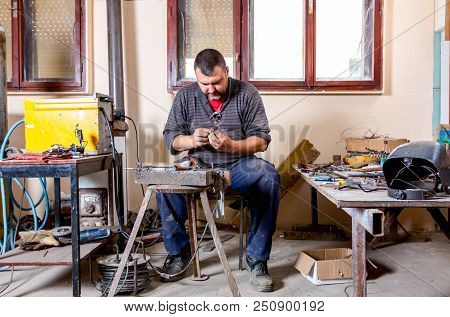 Sculptor Is Giving Stance, Attitude To His Figures Made Of Metal Wire In His Workshop.