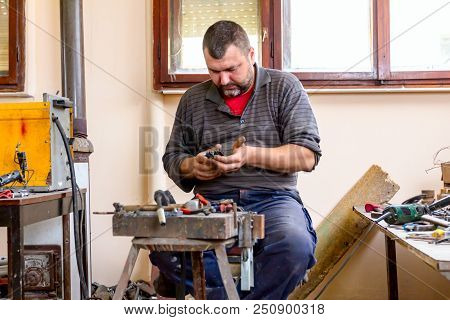 Sculptor Is Giving Stance, Attitude To His Figures Made Of Metal Wire In His Workshop.