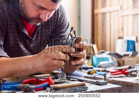 Sculptor Is Giving Stance, Attitude To His Figures Made Of Metal Wire In His Workshop.