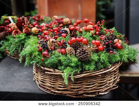 Traditional European Christmas Decoration With Fir-tree, Pinecones And Berries Of Dogrose In A Twigg