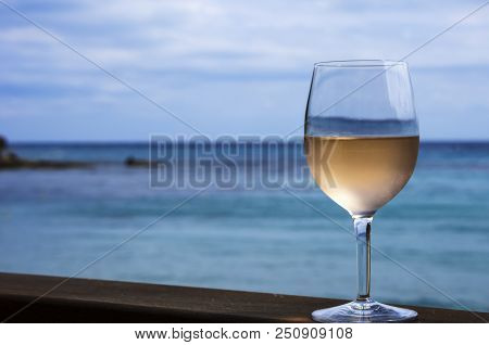 Rose Wine Is In The Sweaty Wineglass. Sea And Sky.