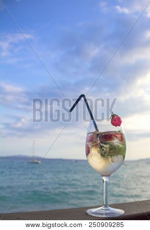 Cocktail With Champagne And Strawberries On A Background Of Sea And Sky. Vertical
