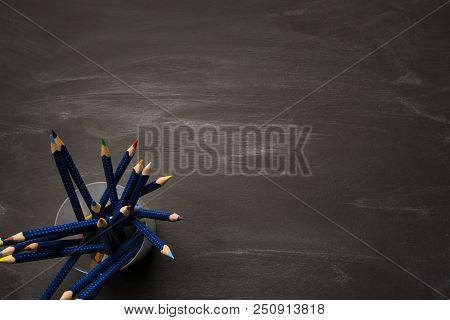 Bank Container With Colored Pencils On Black Chalk Board, School Background, Top View, Copy Space