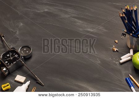 School Supplies, Alarm, Pencils, Apple On Black Chalkboard Top View, Copy Space. Concept: Back To Sc