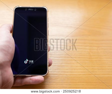 Zhongshan,china-july 21, 2018:man Runs A Mobile App Of Douyin. Douyin Spreads Out Very Fast In China