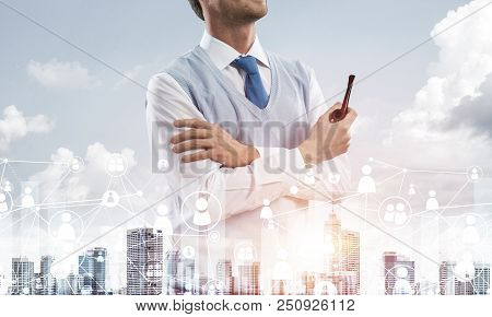 Double Exposure Of Confident And Young Businessman In Smart-casual Wear Smoking Pipe And Modern City