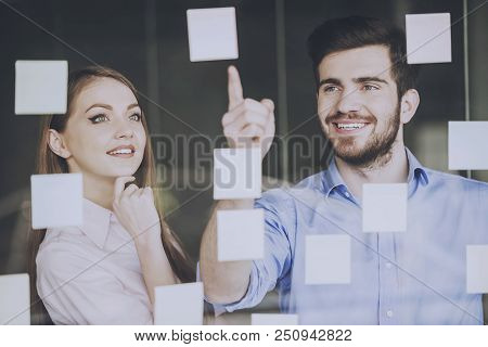 Manager Shows Collegue How To Improve New Project. Stickers On Glass. Business Concept. Attractive P