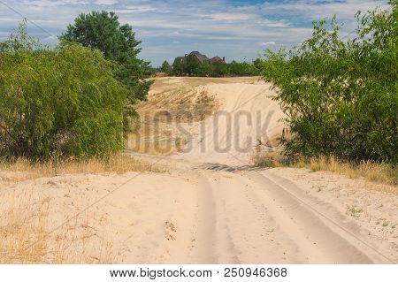 Landscape With Sandy Track Leading To Human Settlement