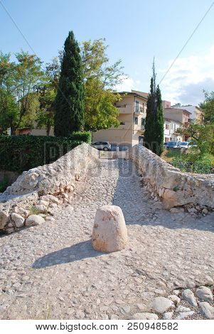 MAJORCA, SPAIN - SEPTEMBER 4, 2017: The Roman bridge across the Torrente de Sant Jordi at Pollenca on the Spanish island of Majorca. The actual origin of the bridge is unconfirmed.