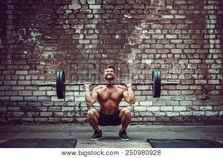 Muscular Fitness Man Doing Deadlift A Barbell Over His Head In Outdoor, Street Gym. Functional Train