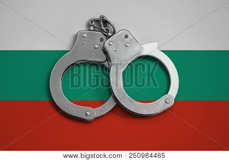Bulgaria Flag  And Police Handcuffs. The Concept Of Observance Of The Law In The Country And Protect