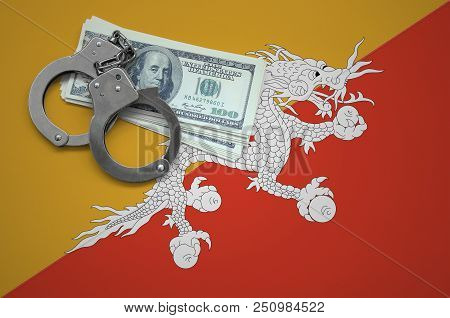 Bhutan Flag  With Handcuffs And A Bundle Of Dollars. The Concept Of Breaking The Law And Thieves Cri