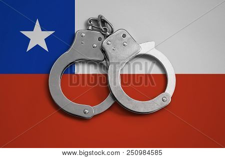 Chile Flag  And Police Handcuffs. The Concept Of Observance Of The Law In The Country And Protection