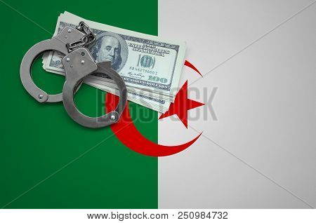 Algeria Flag  With Handcuffs And A Bundle Of Dollars. The Concept Of Breaking The Law And Thieves Cr