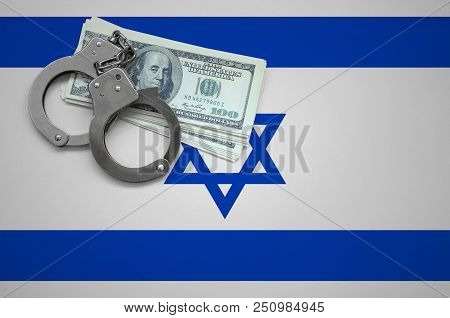 Israel Flag  With Handcuffs And A Bundle Of Dollars. The Concept Of Breaking The Law And Thieves Cri
