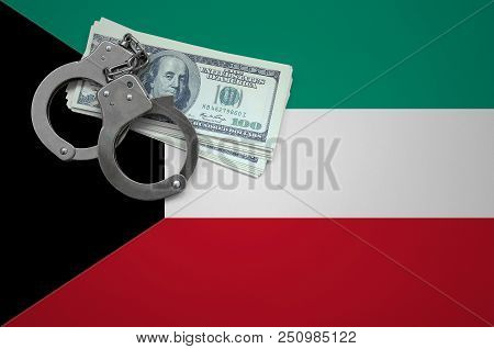 Kuwait Flag  With Handcuffs And A Bundle Of Dollars. The Concept Of Breaking The Law And Thieves Cri