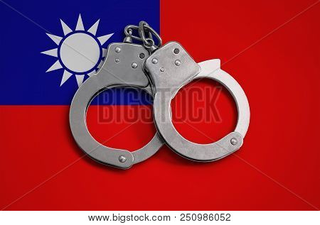 Taiwan Flag  And Police Handcuffs. The Concept Of Observance Of The Law In The Country And Protectio