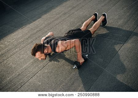 High Angle View Of Handsome Sportsman Doing Push Ups With Dumbbells On Roof