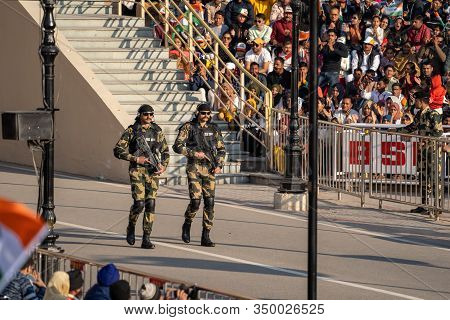 Amritsar India - Febuary 8, 2020: Indian Border Security Force Men With Large Machine Guns And Camo 