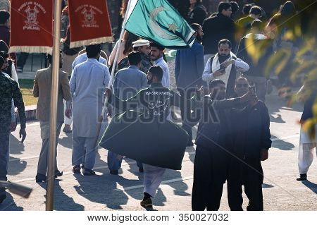 Wagah, Pakistan - Febuary 8, 2020: Pakistani Men Take A Selfie With A Performer Before The Wagah Bor