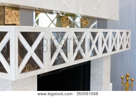 Striped ornament located above the fireplace in the living room.