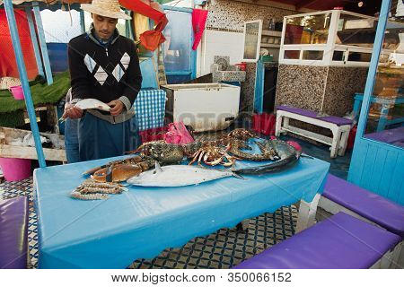 Morocco , Africa, January 16, 2020: Fisherman Displays His Catch In Marocco. Is A Major Tourist Dest